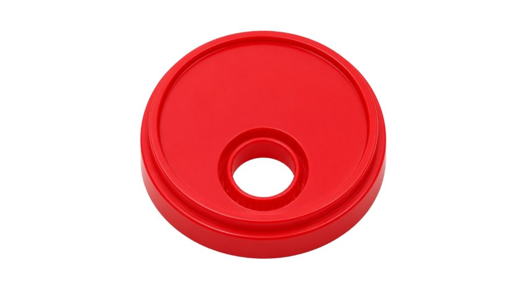Tapa plástica cilíndrica de color rojo sólido fabricada con pellets precoloreados de alta pureza de Tekniset, destacando un acabado estético uniforme y de alta calidad.